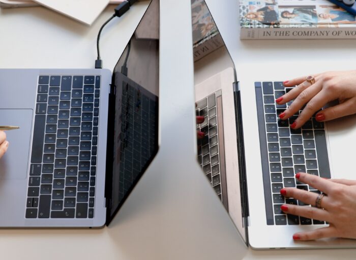 person typing on silver laptop computer